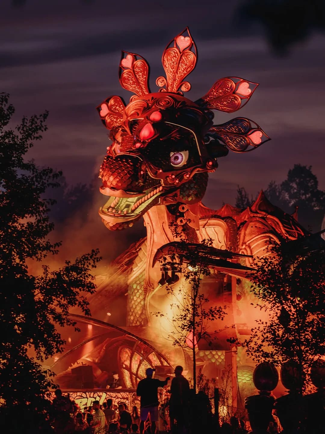 A sculpted creature stage set against a purple dusk sky